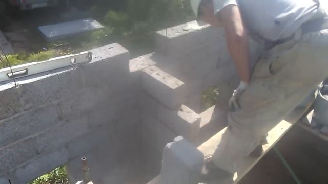 Баня из керамзитобетонных блоков с шиферной крышей и флюгером