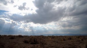 Time-lapse of a desert plain and clouds.