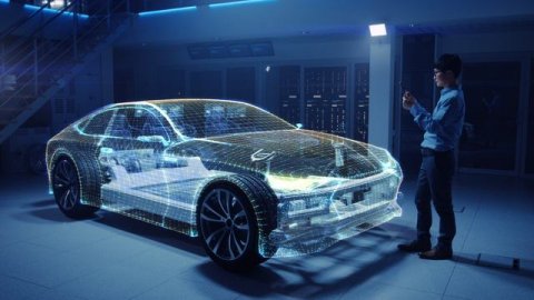 19_34_02_Modern_Engineer_Holds_Tablet_Computer_Uses_Augmented_Reality_to_Work_on_Electric_Car_Concep