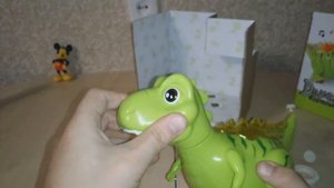 Игрушка музыкальный динозавр.