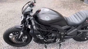 Benelli 502c with clip-on bars and blacked out forks.