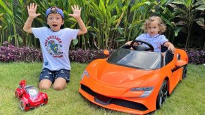 Mark King and baby Rostik plays with toy cars