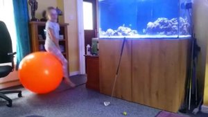 Girl bouncing on orange retro space hopper