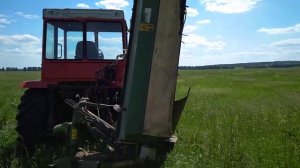 Гусеничный трактор Дт-75 на колесах с косилкой Krone