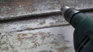 Снятие старой краски с деревянного окна с помощью электродрели.