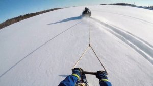 На сноуборде за снегоходом.