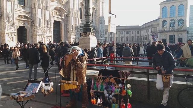 Достопримечательности в Милане/Уличный музыкант на площади Дуомо в городе Милан, Италия  Ломбардия