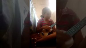 Samara tocando e cantando um pedaço da música Hey Pai