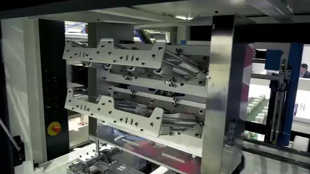 Side entry IML system for plastic products