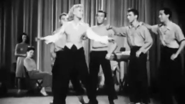 Marjorie Reynolds (dubbed by Martha Mears) and men's chorus - Is It Worth It?