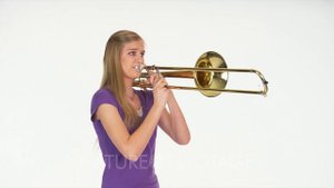 Woman Model In Studio With White Background Playing Trombone