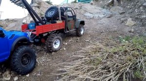 AXIAL scx10 2 wrecker with remote boom, rescues ford f150 from the bottom of a rocky gorge