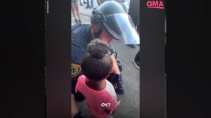 Police officer comforts little girl after she asks: 'Are you going to shoot us?' l GMA Digital