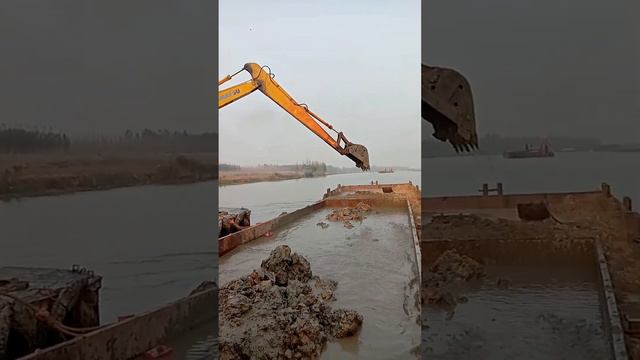 Amphibious excavator is dredging the river