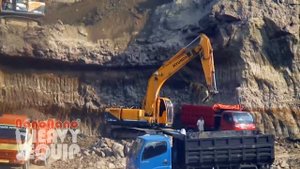 Excavator Hyundai 220 Loading sands to Dumper truck at Cliff minning site