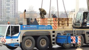 Автокран Терекс выгружает балласт для башенного крана.