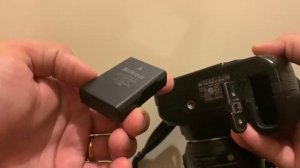 Battery insert or remove on Nikon D3100 DSLR.