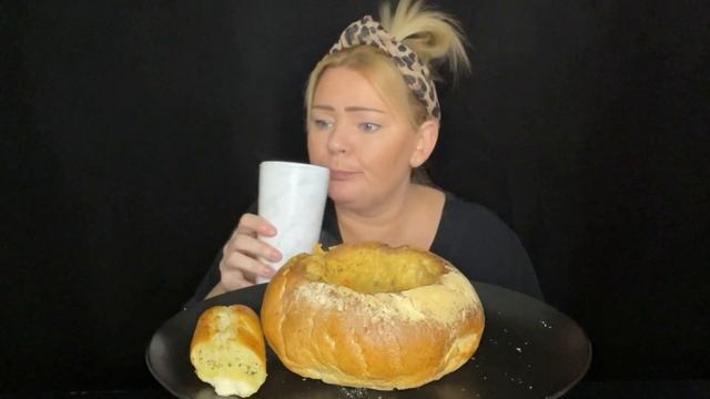 Vegetable soup in a bread bowl with garlic baguette