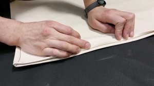 Как можно скрыть скобы, забивая заднюю стенку мебели тканью.