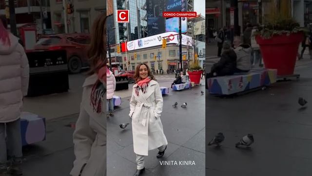 Globally acclaimed author and Realtor, VINITA KINRA, walks in Toronto's iconic Dundas Square.