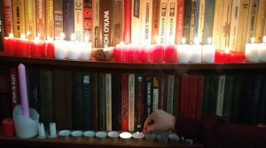 candles in a bookcase. свечи в книжном шкафу