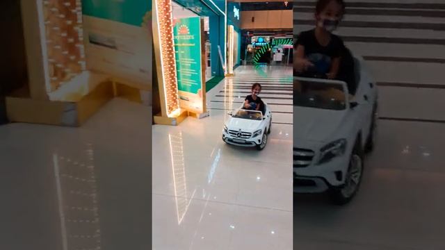 Kid driving car in a mall