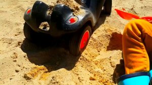 Маленькая машинка застряла в песке