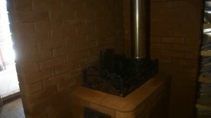 Банная печка Горыныч. Сделали портал и стилизовали под камин.