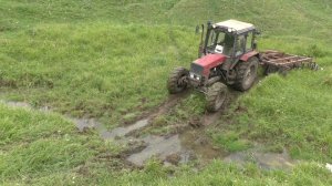 The tractor overcomes a large ravine in the mud!