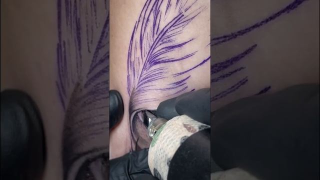 Feather with flowers tattoo