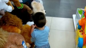 Малыш в восторге от мягких игрушек в магазине "Детский мир"