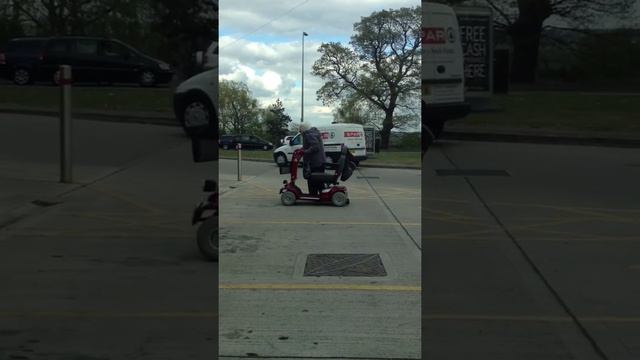 Granny parks mobility scooter in disabled bay