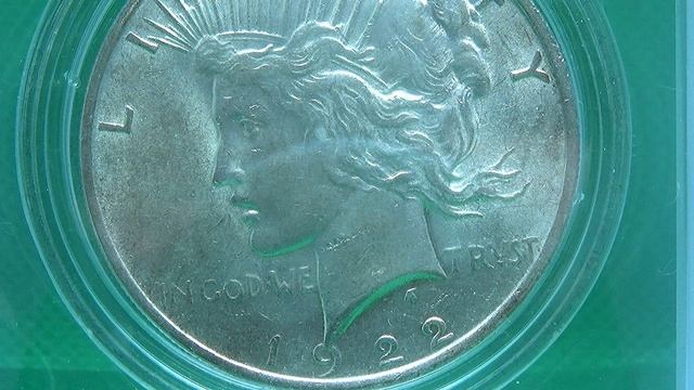 Монета с инопланетянином. США 1 доллар унция шага. Серебряный маргоновский доллар 1921 года. Мирный доллар. 1 унция в долларах