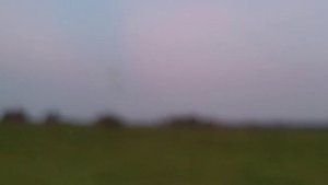 над полем низко