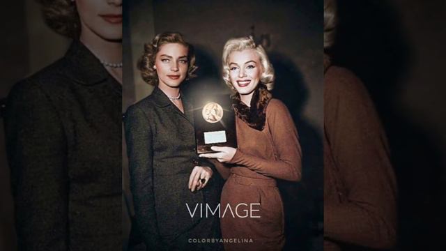 Lauren Bacall gives Marilyn Monroe the 1953 Photoplay Magazine award.