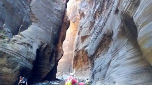 Hiking inside the massive canyon walls of Zion Narrows at Zion National Park in Utah USA