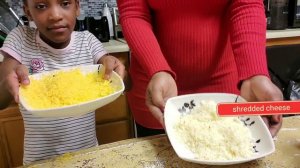 Mama and daughter cooking home made chicken quesadillas.