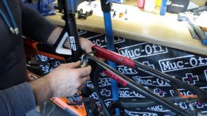 Removing bearings from a seat stay in a suspension bicycle frame.