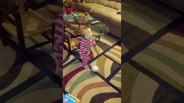 10 month old dribbling his small soccer ball after just learning to walk