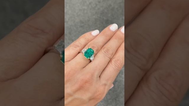 4.70-carat green emerald trilogy with 1-carat trapezoid cut on each side