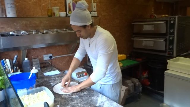 A Pizza Spinning Master In Action - Italian Pizzeria Shop Seen In Camden Stables Market, London....