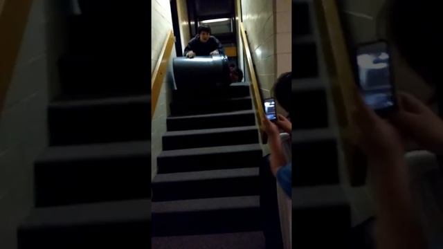 Awesome kid goes down stairs in garbage can