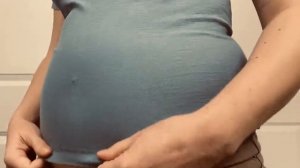 Пухленькая девушка натягивает на себя футболку