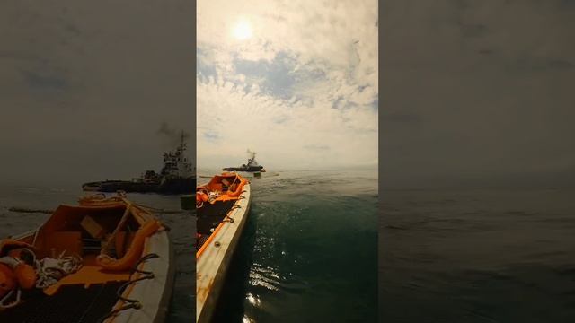 Two workboats supporting Tugboat in maintenance operations.