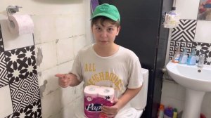 Весельчак сидит на унитазе, отвалилась плитка в туалете