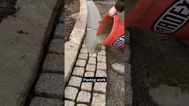 Pavement construction - worker laying granite stone pavers & pouring grout