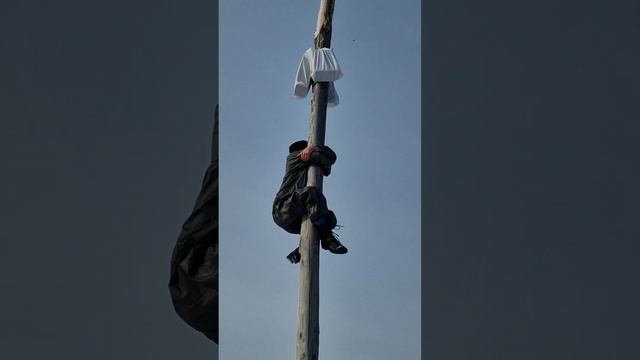 A man climbs a pole for a gift. Maslenitsa time in Siberia. From Russia with Love ❤️