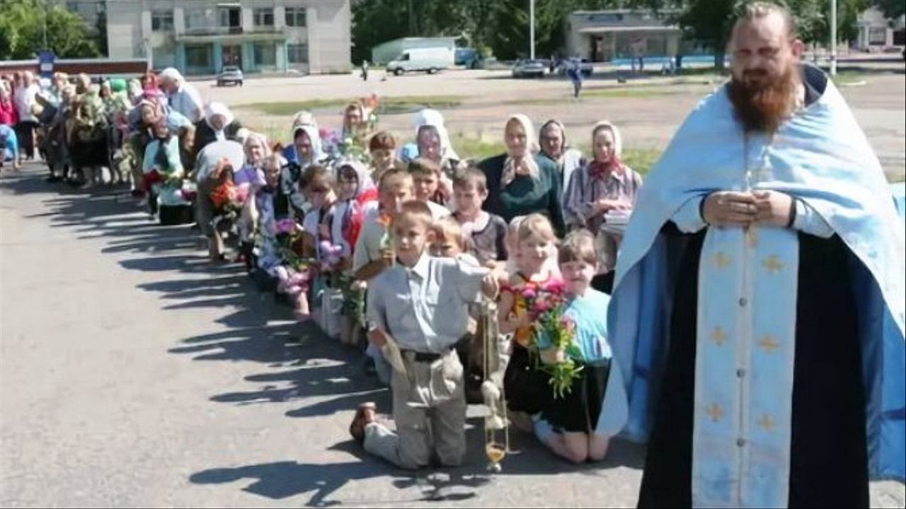 Священник молится на коленях