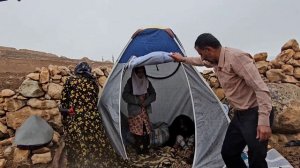 "A kind man helping a homeless family in heavy rain "