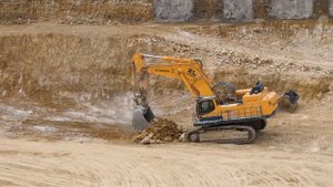 Hyundai R1200-9 cleaning up and loading trucks at a site in Luxembourg.